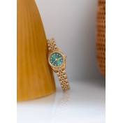 Women's gold and green watch